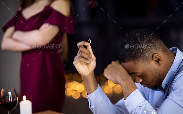 Desperate Black Man Sitting With Ring In Hand After Girlfriend Refused Proposal