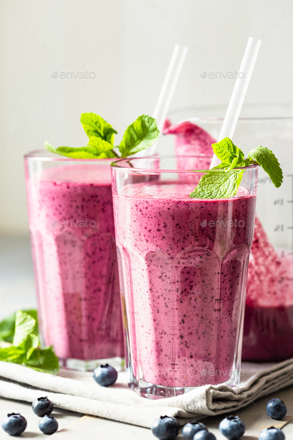 Two Glasses of Smoothie on Table. Vertical. Stock Photo by fucsiya