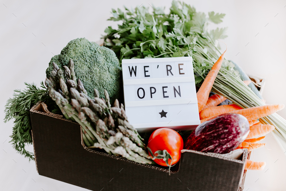 Text We\'re open and Fresh green and vegetables box
