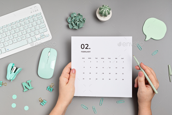 Desktop with calendar for february and office supplies - Stock Photo - Images