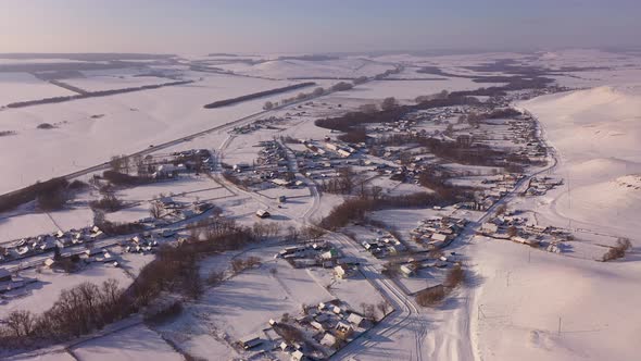 Aerial View of a Winter Village in a Hilly Area