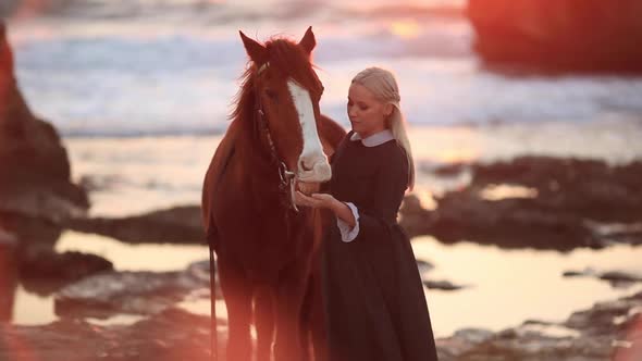 Woman with Horse on Rocky Seashore Slow Motion Full