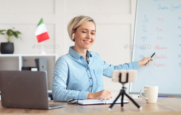 Teaching Italian online. Positive female tutor conducting remote foreign language class, using