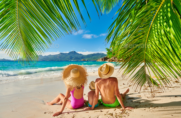 Family with three year old boy on beach. Seychelles, Mahe. - Stock Photo - Images