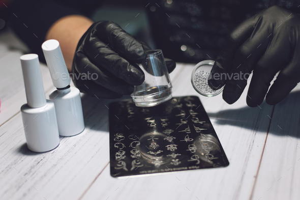 Nail Art Stamping process. Manicure master makes Stamping with nail gel polish, Stamping Plates and