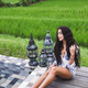 Young slim girl relaxing near luxury pool in Bali rice fields - PhotoDune Item for Sale