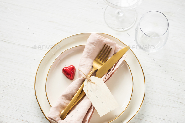 Romantic Table Setting with Golden Cutlery.