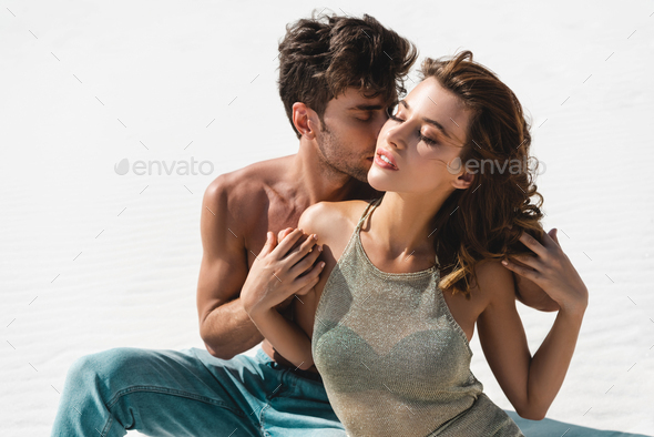 passionate sexy young couple kissing on beach with closed eyes Stock Photo  by LightFieldStudios