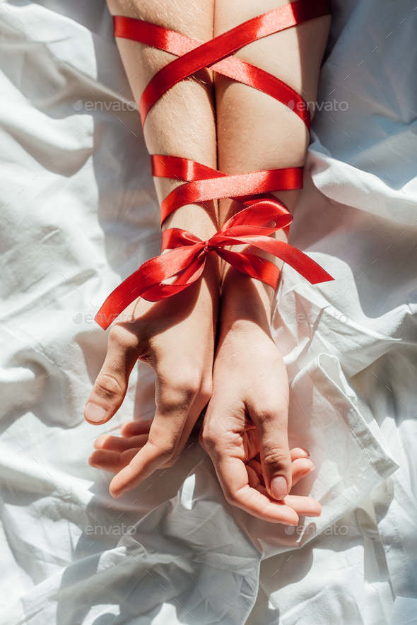 two female hands and red silk ribbon - a Royalty Free Stock Photo from  Photocase