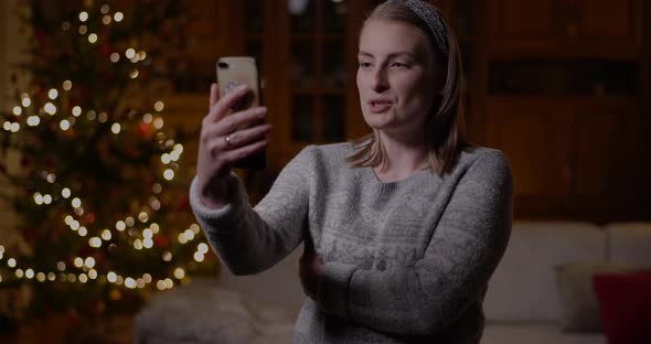 Woman Doing Videocall or Videochat Video Chatting Christmas Smartphone alt