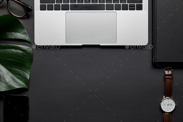 Composition with laptop and business accessories on black background - Stock Photo - Images