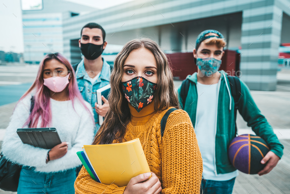Portrait of a group of students covered by face masks.