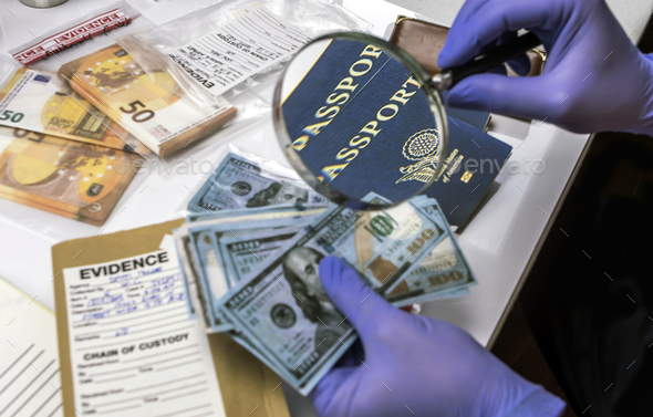 Expert police officer examining American passport of a evidence bag in laboratory