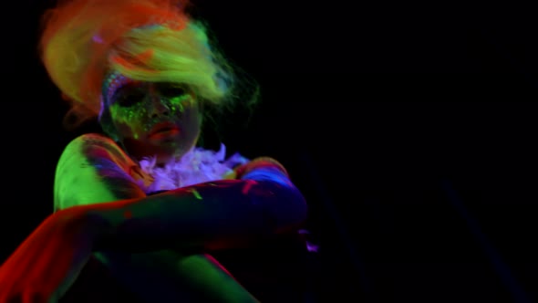 Green Red and Yellow Glowing Paints on Woman Lady is Dancing Slowly in Darkness alt