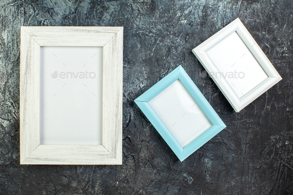 Top view of three picture frames in different sizes on icy black background