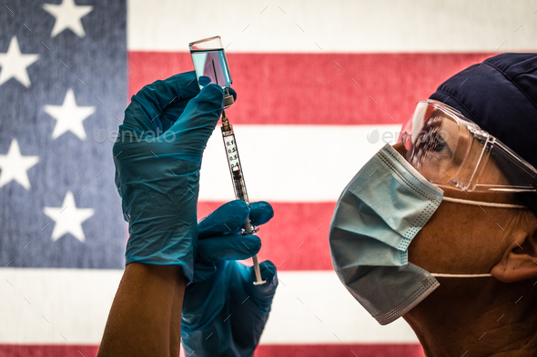 Front Line Worker Holding Syringe and Vial Filled with Coronavirus Vaccine