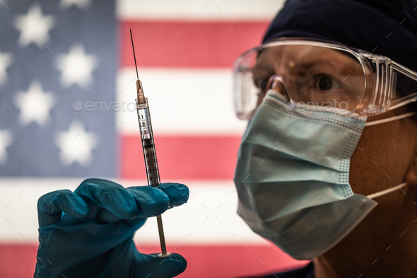 Front Line Worker Holding Syringe and Vial Filled with Coronavirus Vaccine