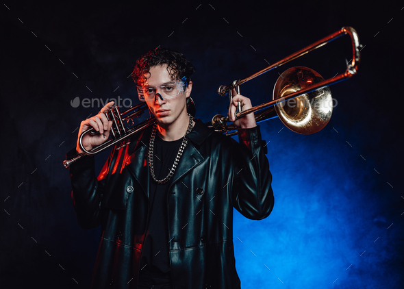 Serious musician with brass and saxophone in dark background Stock Photo by  fxquadro