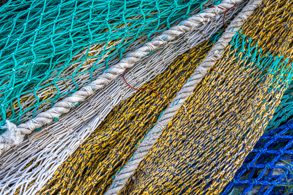 Background with close up of fishing nets, blue, green, yellow