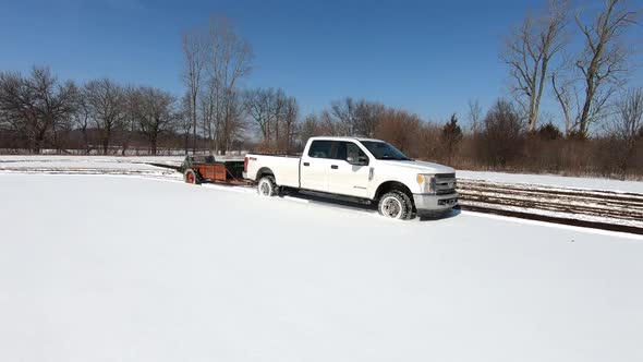 White Truck With Manure Spreader On Fields Thickly Covered With Snow In Southeast Michigan - Fertili alt