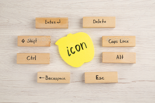 top view keyboard icons on wood blocks icon written on sticky note on wooden table