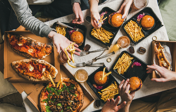 Lockdown fast food dinner from delivery service, getting together - Stock Photo - Images