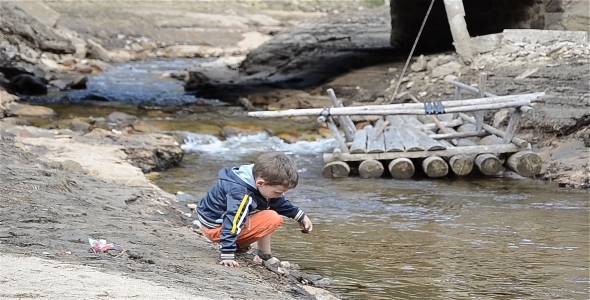 Child Playing Near the River 