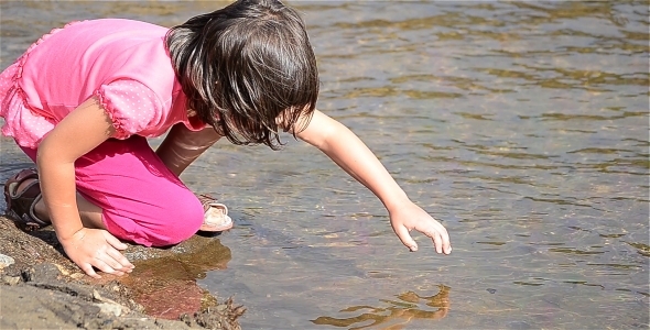 Girl Playing In Water