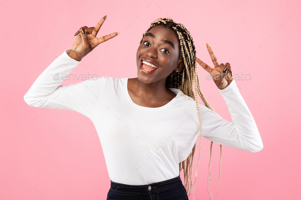 Black woman showing two victory sign or peace gesture