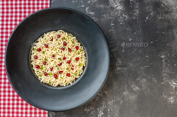 top view ramen noodles on round plate red and white checkered tablecloth on dark table with free