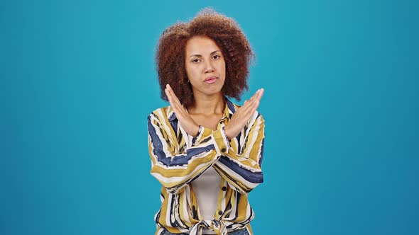 African American Lady Crosses Hands Showing Stop Gesture alt