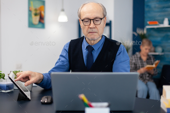 Portrait of mature man doing websurfing - Stock Photo - Images