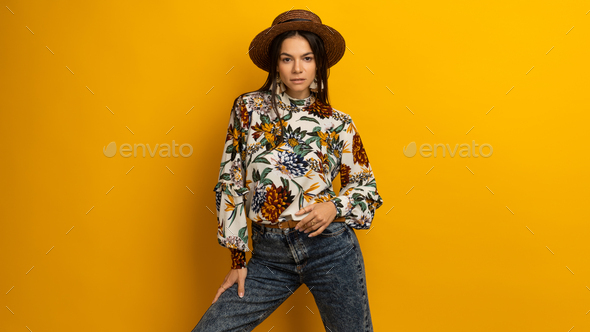 woman posing isolated on yellow studio background in trendy fashion clothes  outfit, Stock Photo by marymandarinka