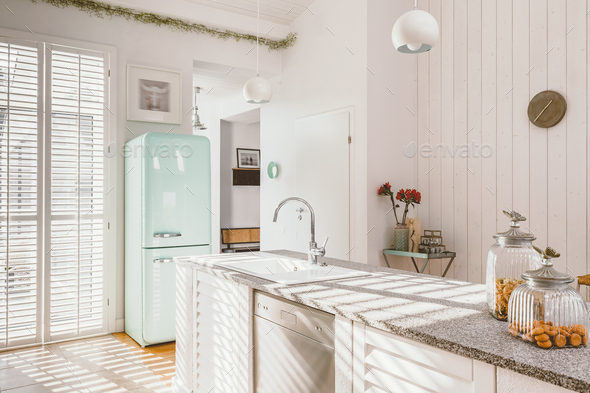 Bright kitchen interior with modern white furniture, pastel mint fridge  Stock Photo by bialasiewicz