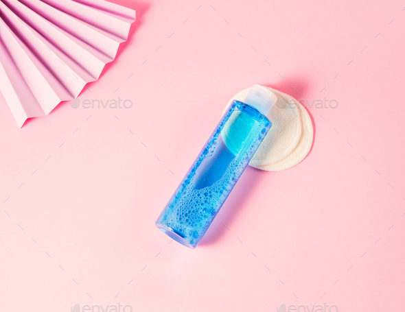 Skin care toner bottle on pink geometrical background