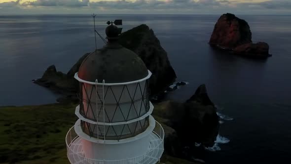 Flying around lighthouse during sunset