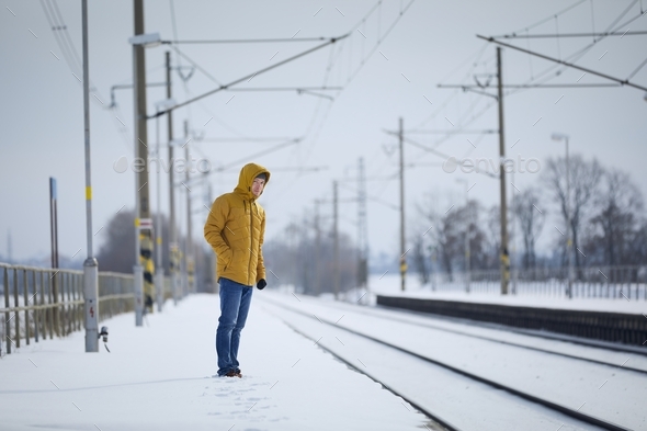 Man standing on platform and waiting for delayed train