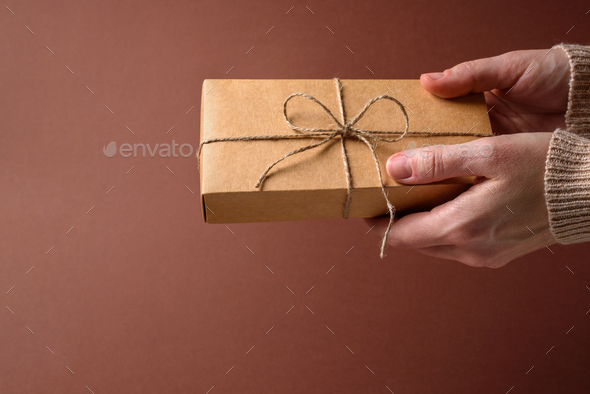 Paper gift box with twine bow Stock Photo by molenira