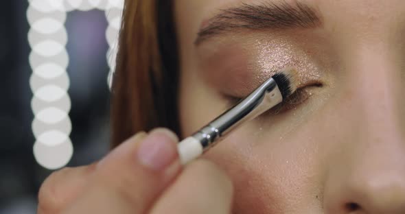 Closeup of Perfect Nude Makeup Process for Young Female Model alt