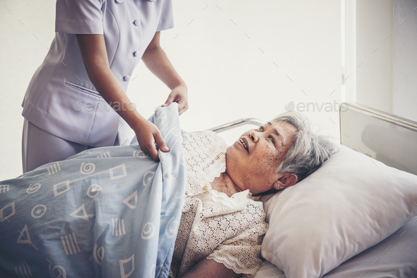 Young Nurse take care for elderly patients during hospital admission. - Stock Photo - Images
