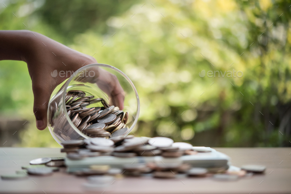 Hand  putting coins in jar with money stack step growing growth saving money - Stock Photo - Images