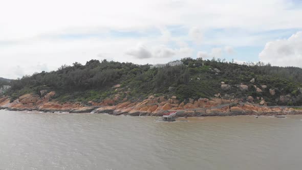 Aerial pan shot of stunning coastal trail in Coloane, Macau alt