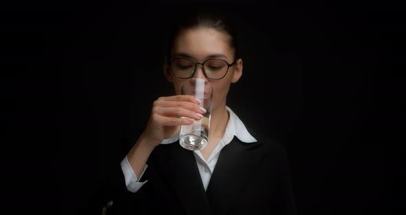 Beautiful Business Woman Drinks Water From a Clear Glass