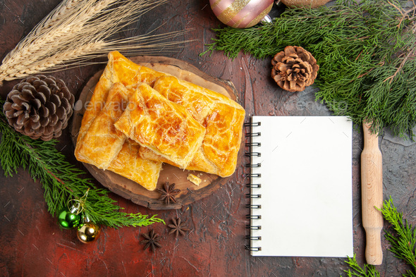 top view penovani khachapuri on wood board rolling-pin pine tree branches and cones a notebook on - Stock Photo - Images