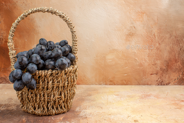 front view fresh black grapes inside basket on light background fruit wine  color photo Stock Photo by KamranAydinovStudio