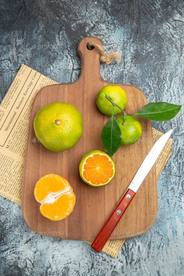 Fresh Sliced Citrus Fruits On Cutting Board With Wooden Squeezer Stock  Photo, Picture and Royalty Free Image. Image 54964192.