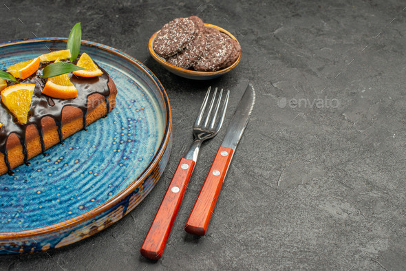 Horizontal view of delicious cake and biscuits with fork and knife on black background footage