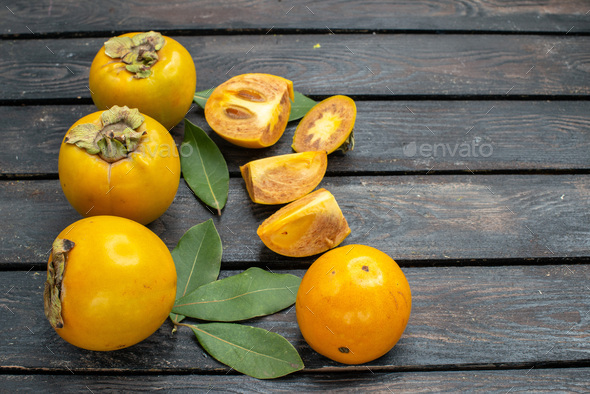 front view fresh sweet persimmons on wooden rustic desk fruit ripe mellow tree