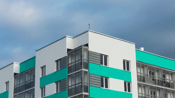 Aerial View of a Residential Building Against the Backdrop of an Urban Landscape alt