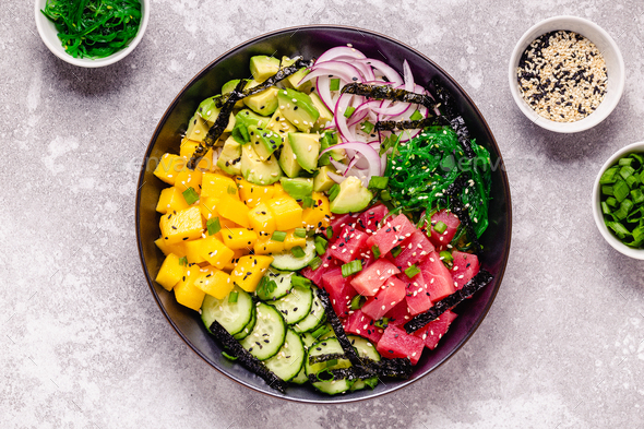 Hawaiian tuna poke bowl with seaweed, avocado, mango, cucumber. Stock ...